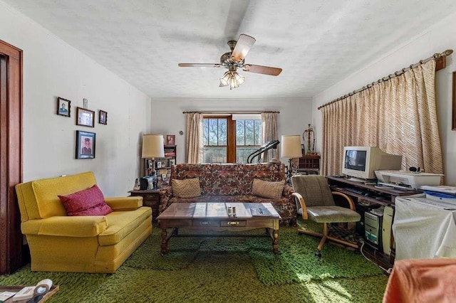 living room with ceiling fan, carpet, and a textured ceiling