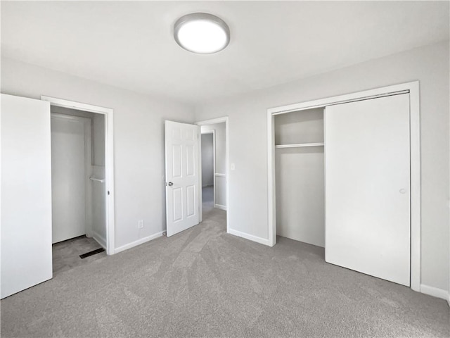 unfurnished bedroom featuring light carpet, a closet, and white fridge