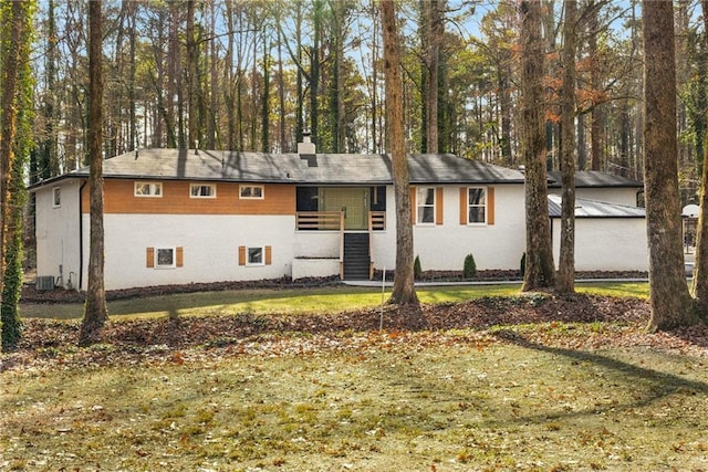 single story home featuring a front yard and central AC unit