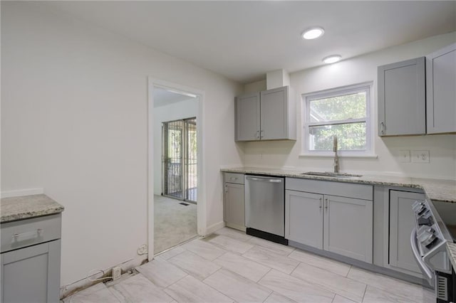 kitchen with a sink, stove, gray cabinets, stainless steel dishwasher, and plenty of natural light