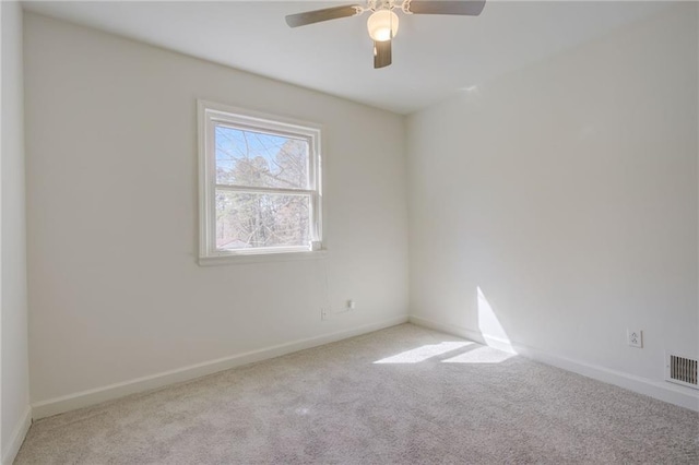 spare room with visible vents, baseboards, a ceiling fan, and carpet floors