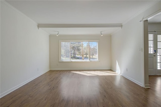 empty room with crown molding, baseboards, wood finished floors, and a healthy amount of sunlight