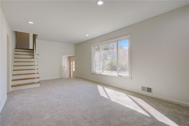 unfurnished living room with visible vents, light carpet, and recessed lighting