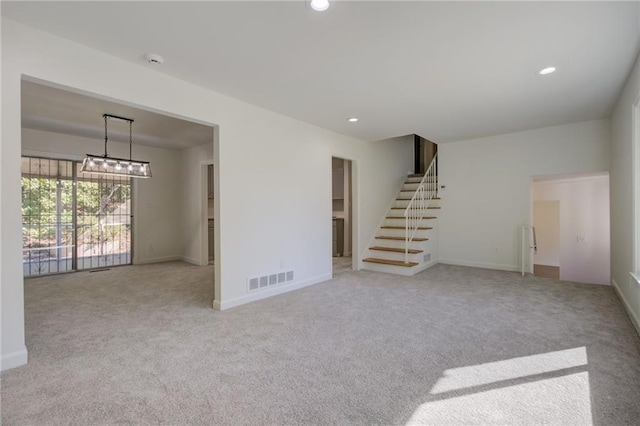 unfurnished living room with stairway, visible vents, baseboards, recessed lighting, and carpet