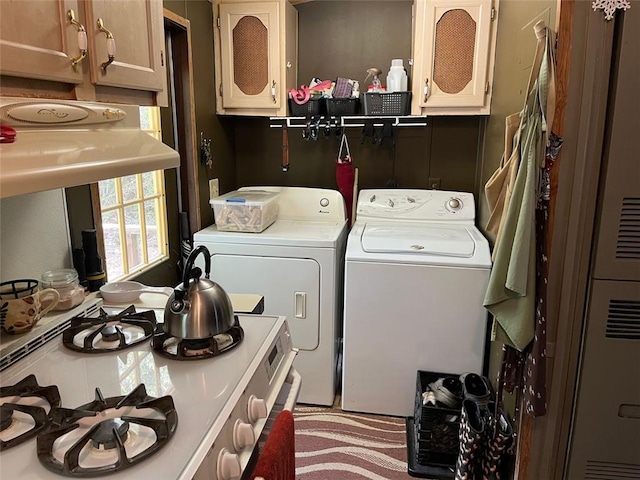 washroom featuring a heating unit, laundry area, and washer and clothes dryer