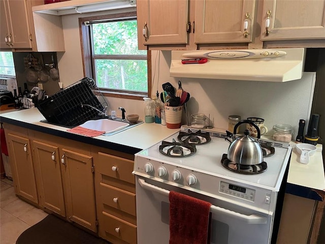 kitchen featuring extractor fan, light tile patterned floors, and white gas range