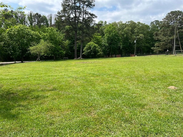 view of yard featuring a forest view