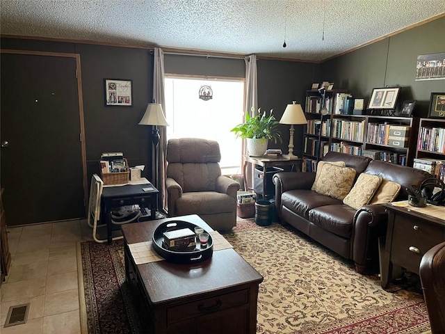 living area featuring a textured ceiling, visible vents, and ornamental molding