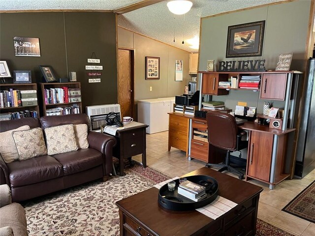 office space with heating unit, light tile patterned floors, a textured ceiling, and lofted ceiling