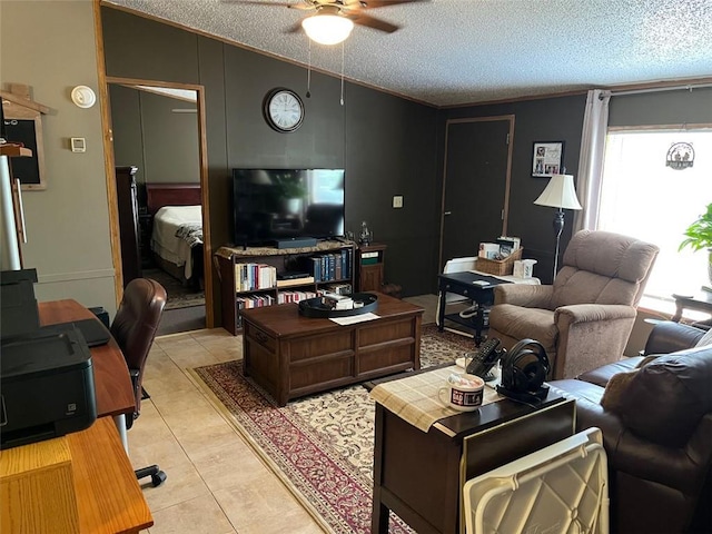 living area featuring a ceiling fan, a textured ceiling, lofted ceiling, and light tile patterned floors