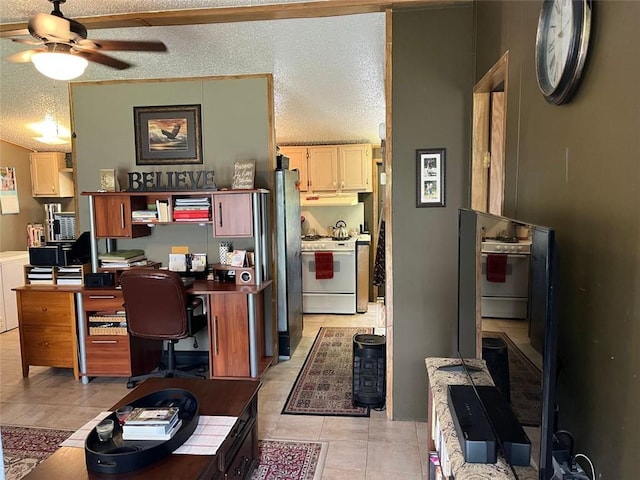kitchen with light tile patterned flooring, ceiling fan, white gas range, a textured ceiling, and under cabinet range hood