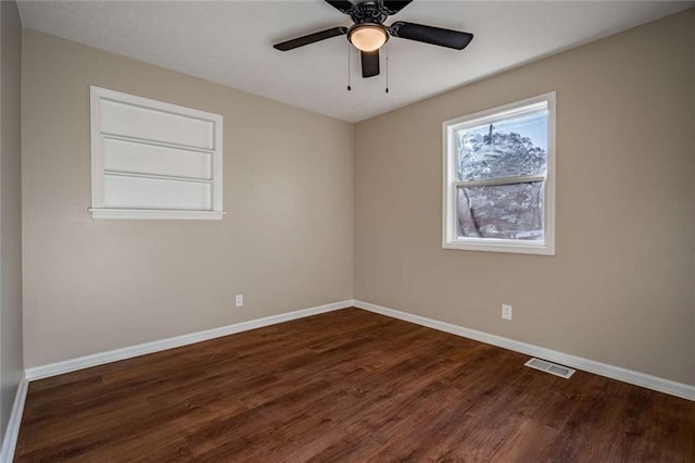 spare room with ceiling fan and dark hardwood / wood-style flooring