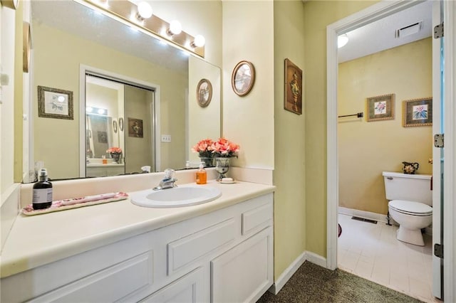 bathroom featuring toilet, baseboards, visible vents, and vanity