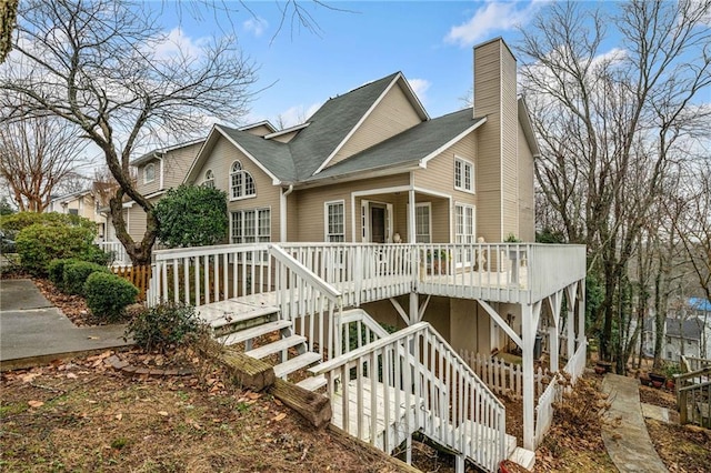 view of front of property featuring a porch, stairway, and a chimney