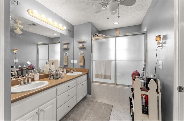 6045 Mockingbird Rd, Cumming, GA 30028 - full bathroom featuring tiled shower / bath combo, a textured ceiling, ceiling fan, and a sink