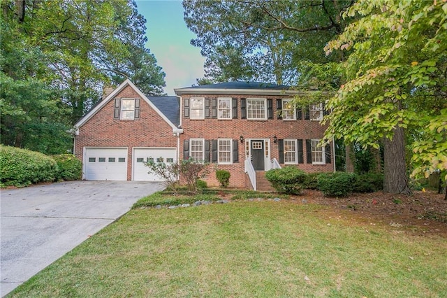 colonial home with a garage and a front yard