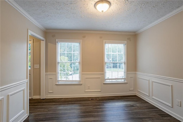 spare room featuring a textured ceiling, dark hardwood / wood-style floors, and ornamental molding