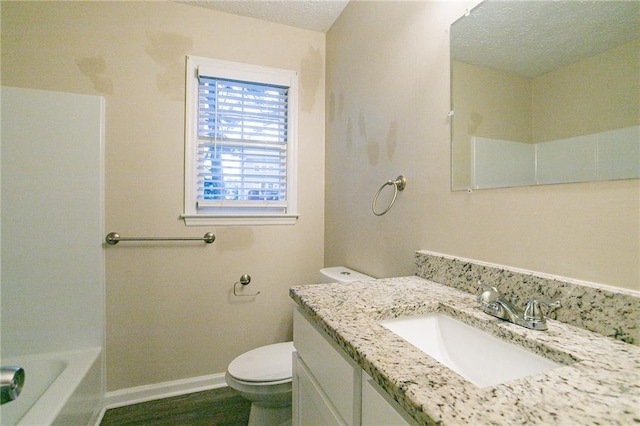 bathroom featuring vanity, toilet, a textured ceiling, and hardwood / wood-style flooring