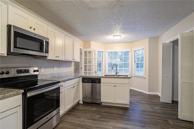 kitchen featuring sink, stainless steel appliances, and white cabinets