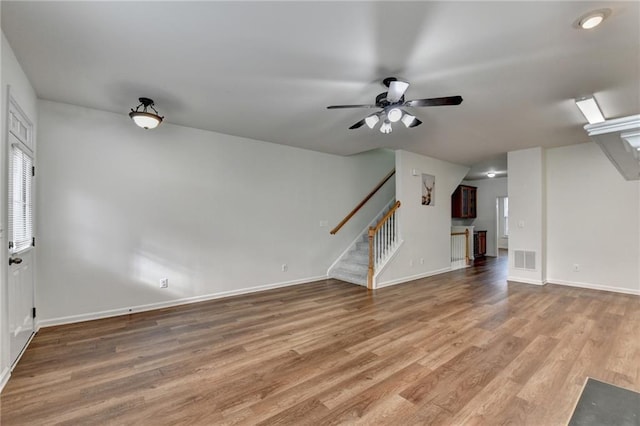 unfurnished living room with hardwood / wood-style flooring and ceiling fan