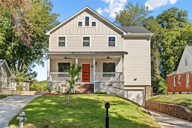 view of front of home with covered porch, concrete driveway, a front lawn, and board and batten siding