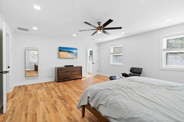 bedroom with recessed lighting, visible vents, light wood-style flooring, and multiple windows