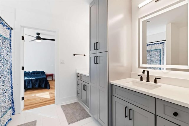 ensuite bathroom featuring tile patterned flooring, ceiling fan, vanity, and ensuite bath