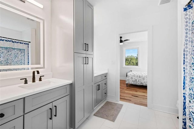 bathroom featuring visible vents, a ceiling fan, vanity, and tile patterned floors