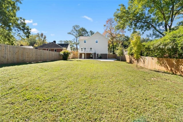 view of yard with a patio area and a fenced backyard