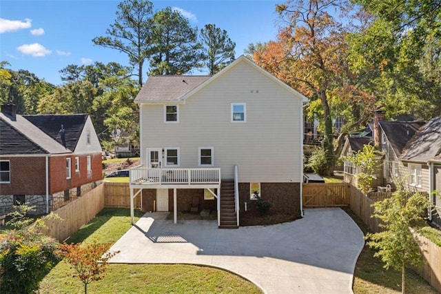 back of property featuring stairway, a patio area, and a fenced backyard