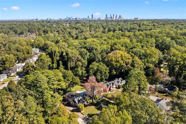 birds eye view of property with a view of trees