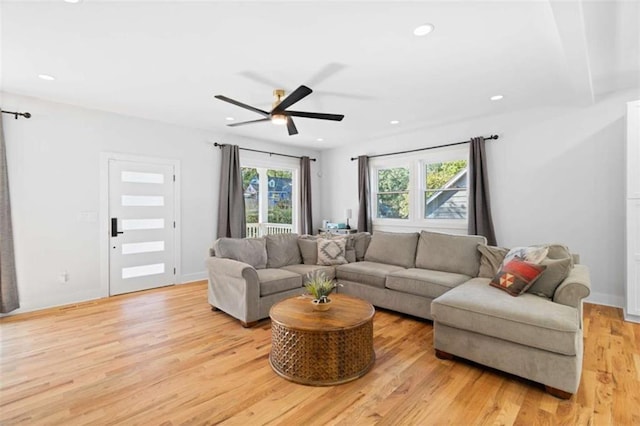 living area featuring ceiling fan, baseboards, light wood-style flooring, and recessed lighting