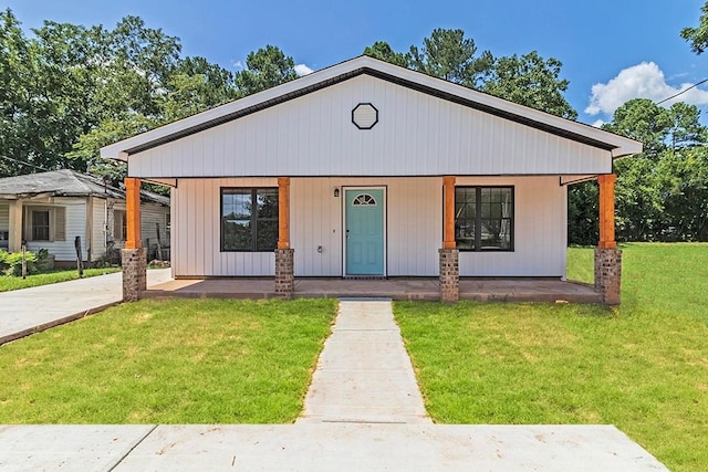 view of front of house with a front yard and covered porch