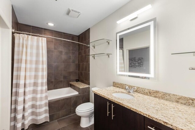 1080 Peachtree St NE Unit 608, Atlanta, GA 30309 - full bathroom with tile patterned flooring, toilet, tiled shower / bath combo, and vanity