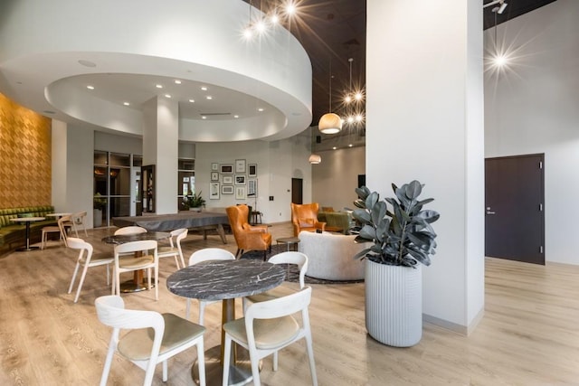 1080 Peachtree St NE Unit 608, Atlanta, GA 30309 - dining area with a towering ceiling, light wood-style flooring, and recessed lighting