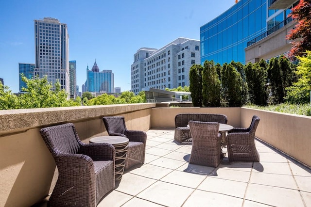 1080 Peachtree St NE Unit 608, Atlanta, GA 30309 - view of patio / terrace with a skyline view and outdoor dining area