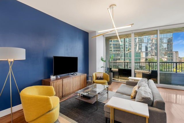 1080 Peachtree St NE Unit 608, Atlanta, GA 30309 - living room featuring a wall of windows, wood finished floors, and an accent wall