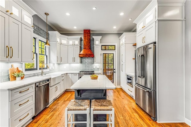 51 River Overlook Ct, Dawsonville, GA 30534 - kitchen with stainless steel appliances, wall chimney exhaust hood, crown molding, decorative backsplash, and light wood finished floors