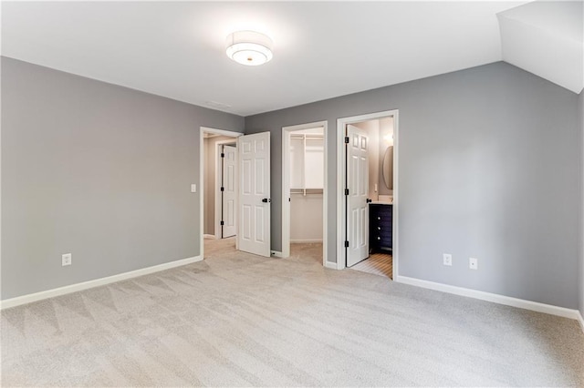 51 River Overlook Ct, Dawsonville, GA 30534 - unfurnished bedroom featuring light carpet, a walk in closet, and baseboards