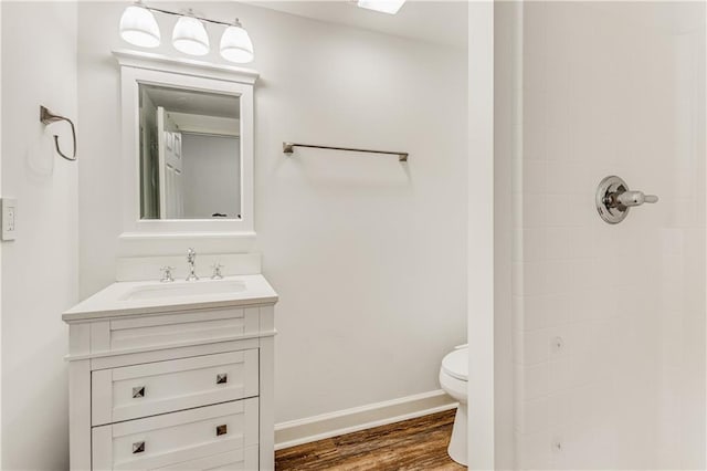 51 River Overlook Ct, Dawsonville, GA 30534 - bathroom with toilet, vanity, a shower, wood finished floors, and baseboards