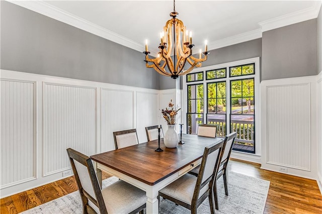 51 River Overlook Ct, Dawsonville, GA 30534 - dining room featuring a decorative wall, a chandelier, ornamental molding, wood finished floors, and wainscoting
