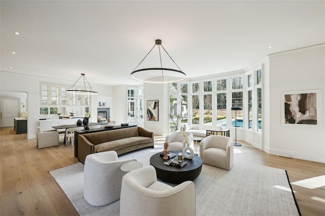 living room featuring light hardwood / wood-style floors and ornamental molding