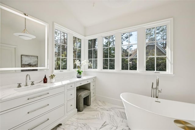 bathroom with vanity, vaulted ceiling, and a bathing tub