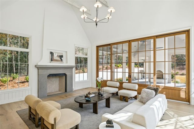 interior space with a chandelier, a healthy amount of sunlight, and lofted ceiling