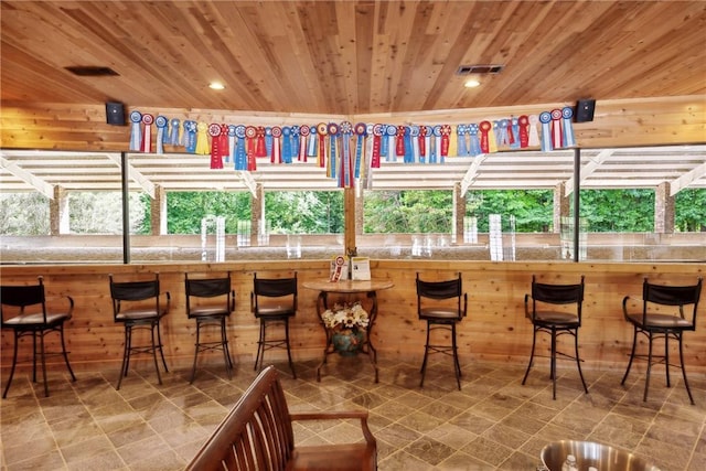 interior space with wood ceiling and bar