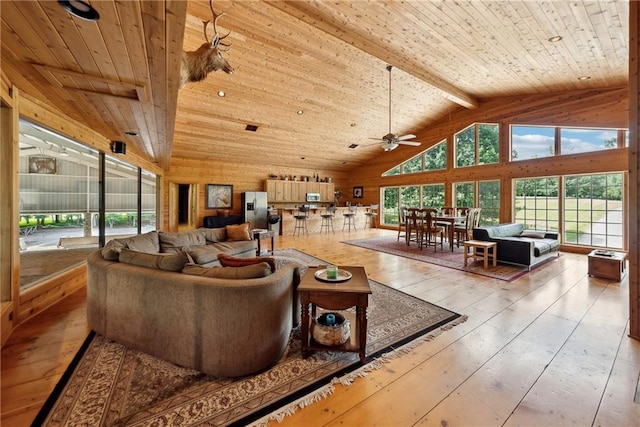 living room featuring hardwood / wood-style flooring, beam ceiling, wooden ceiling, and high vaulted ceiling