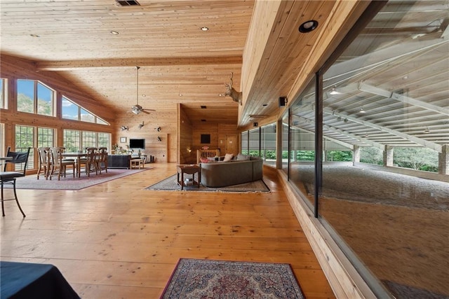 interior space featuring hardwood / wood-style floors, vaulted ceiling with beams, a healthy amount of sunlight, and wood ceiling