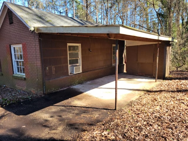 view of property exterior featuring cooling unit and a carport