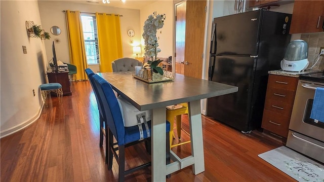 dining room with dark wood-style floors and baseboards