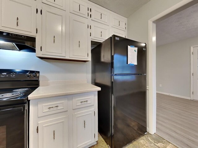 kitchen featuring sink, a textured ceiling, black appliances, and white cabinets